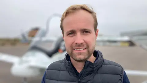 Michael Thompson, CEO of Skyfly standing in front of the Axe two-seater aircraft