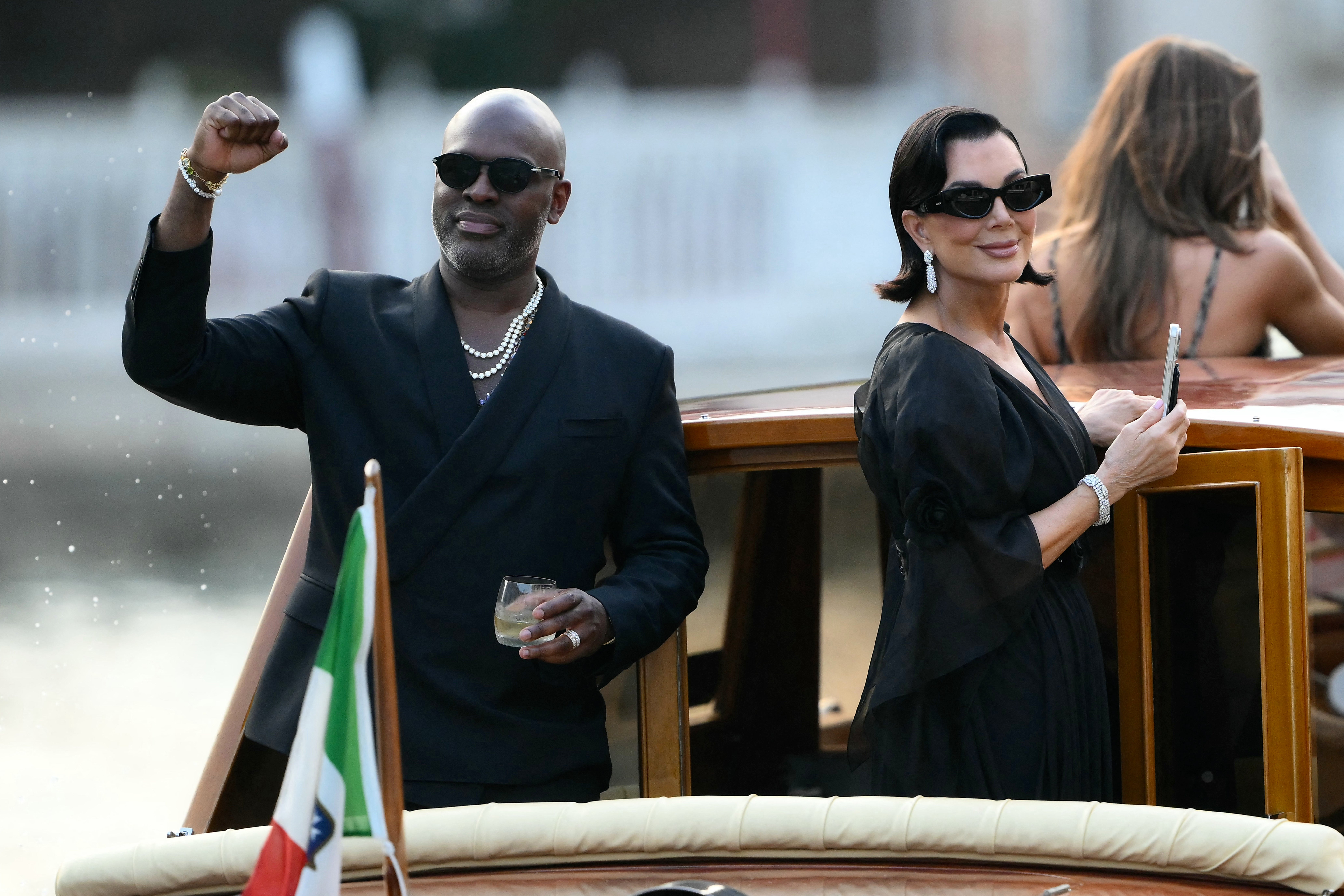 The ‘momager’ was smiling on the boat with her longtime partner Corey Gamble, who wore an all black suit and silver chain